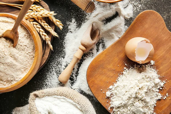 Fresh flour on dark table — Stock Photo, Image