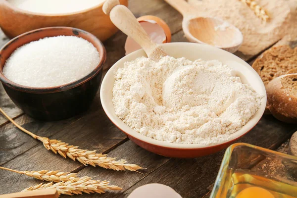 Flour with products on wooden table — Stock Photo, Image