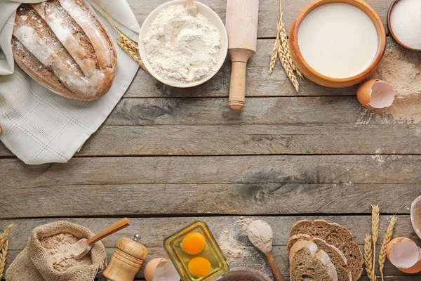 Flour with products on wooden table — Stock Photo, Image