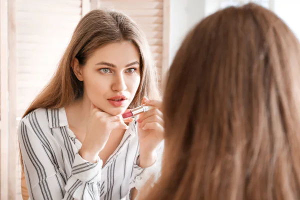 Young woman near mirror in makeup room — Stock Photo, Image