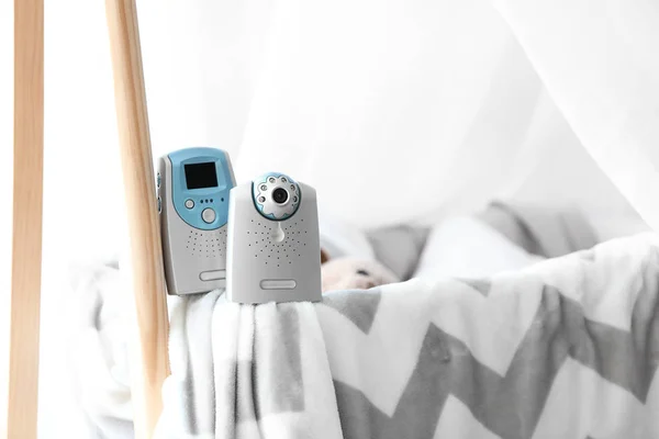 Video baby monitor on cradle in room — Stock Photo, Image