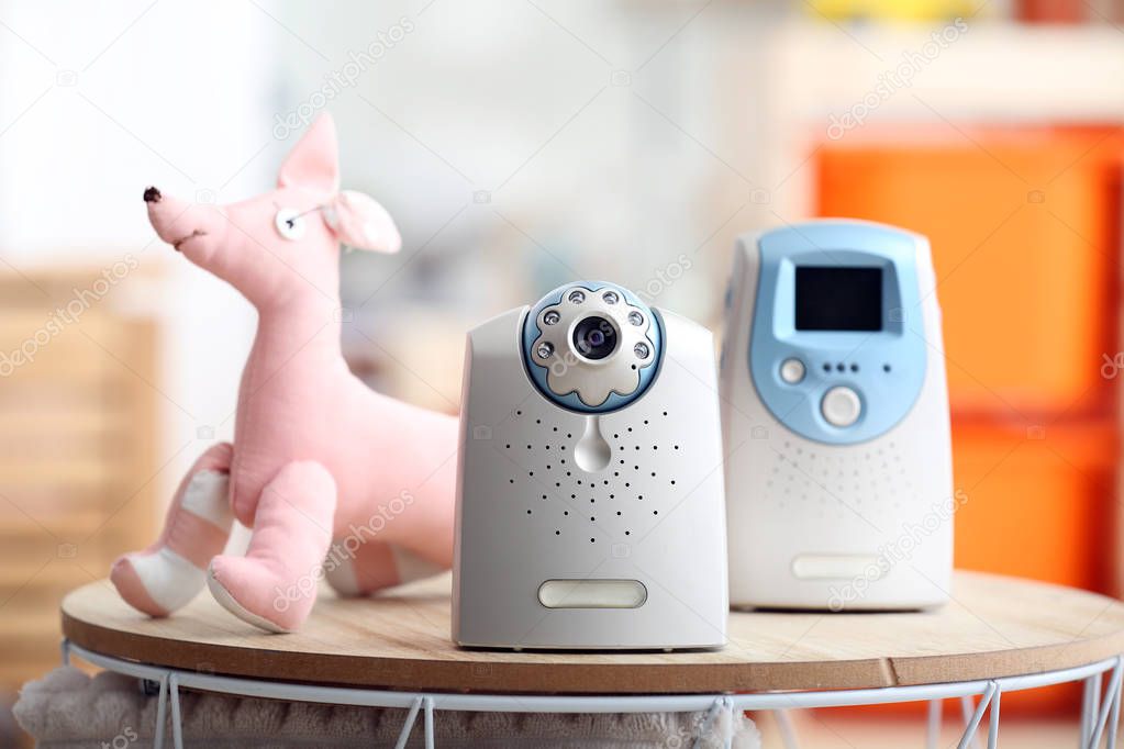 Video baby monitor on table in room