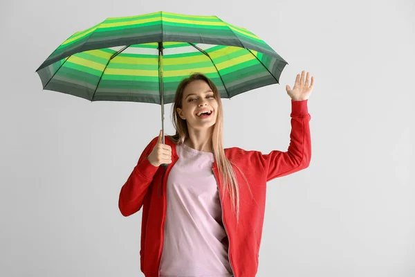 Beautiful young woman with umbrella on white background — Stock Photo, Image