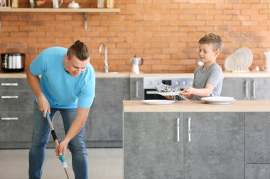 Baba ve oğlu birlikte mutfak temizliği