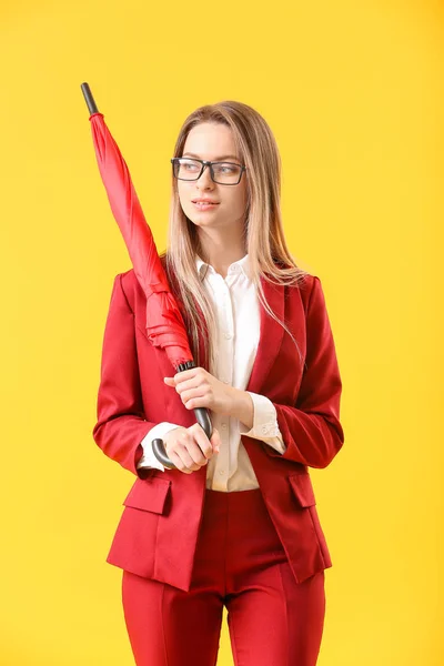 Beautiful businesswoman with umbrella on color background — Stock Photo, Image