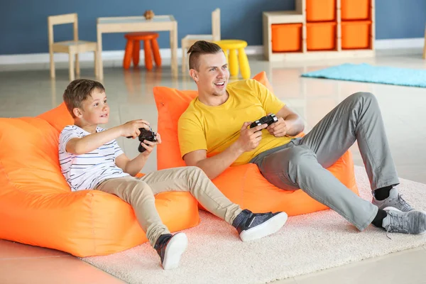 Retrato de padre e hijo jugando videojuegos en casa —  Fotos de Stock