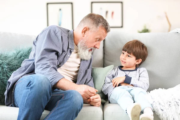 Cute little boy with grandfather at home — Stock Photo, Image