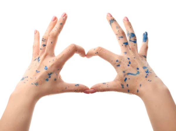 Female hands with paint showing heart shape on white background — Stock Photo, Image