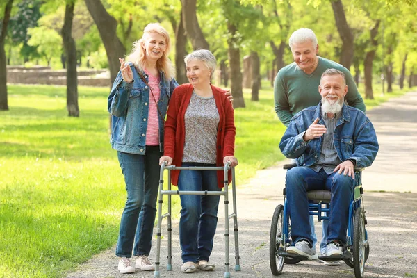 Group of senior people walking in park — Stock Photo, Image