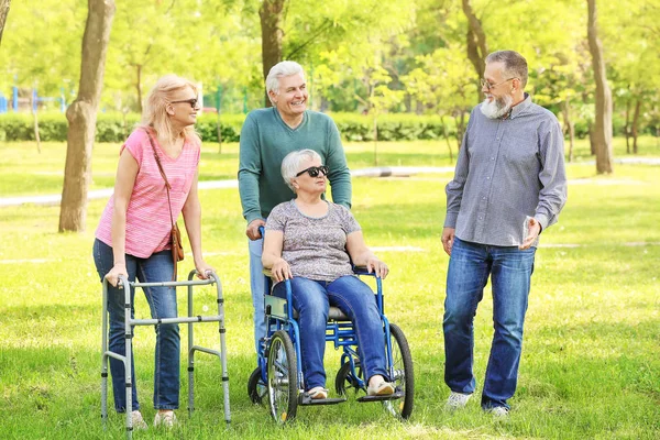 Group of senior people walking in park — Stock Photo, Image