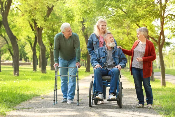 Group of senior people walking in park — Stock Photo, Image