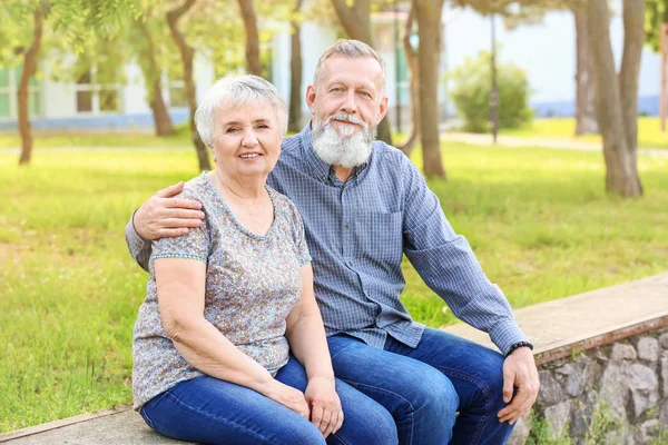 Portrait of happy senior couple in park — Stock Photo, Image
