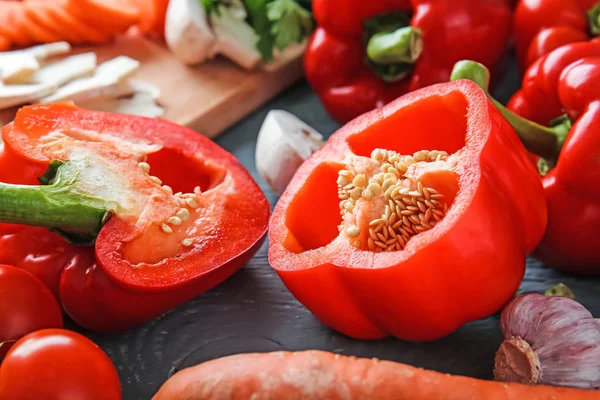 Ripe red peppers with other vegetables on table — Stock Photo, Image