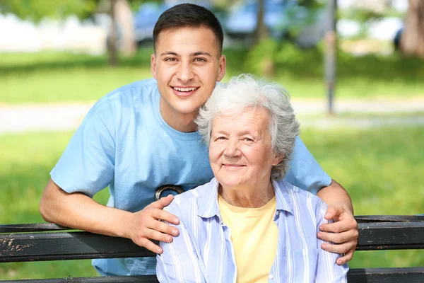 Grandson with senior woman in park — Stock Photo, Image