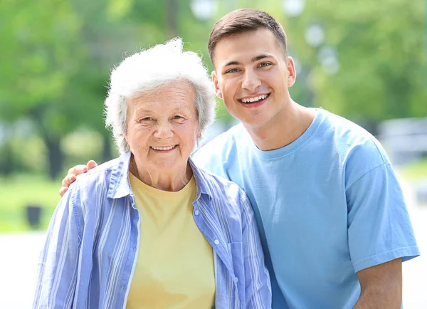 Grandson walking with senior woman in park — Stock Photo, Image