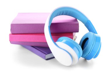 Books and modern headphones on white background. Concept of audiobook clipart