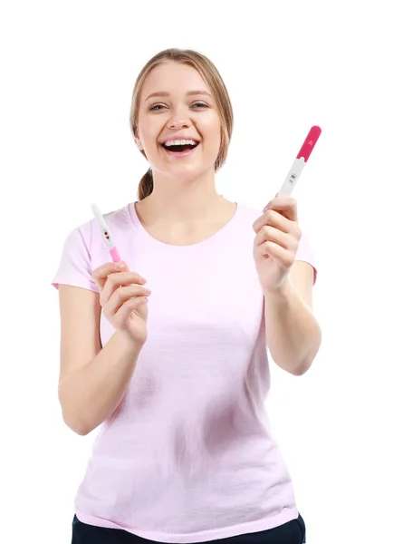 Happy young woman with pregnancy test on white background — Stock Photo, Image