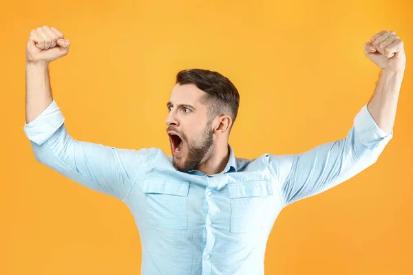 Happy successful handsome man on color background — Stock Photo, Image