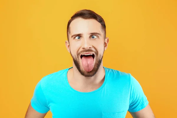 Funny grimacing man on color background — Stock Photo, Image