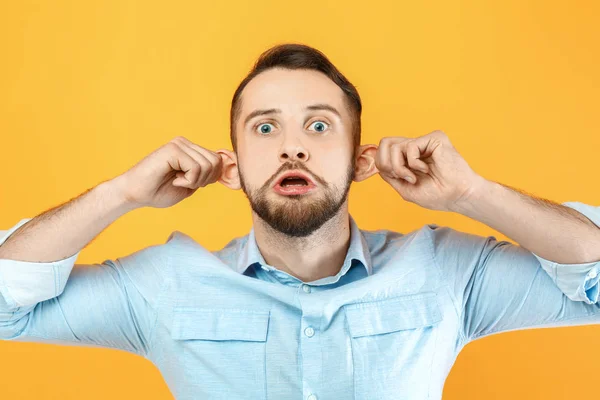 Funny grimacing man on color background — Stock Photo, Image