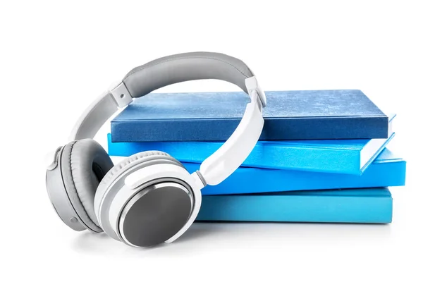 Libros y auriculares modernos sobre fondo blanco. Concepto de audiolibro — Foto de Stock