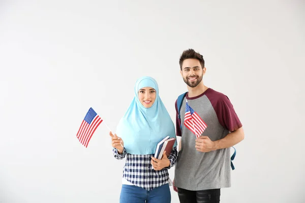 Students with USA flags on light background — Stock Photo, Image