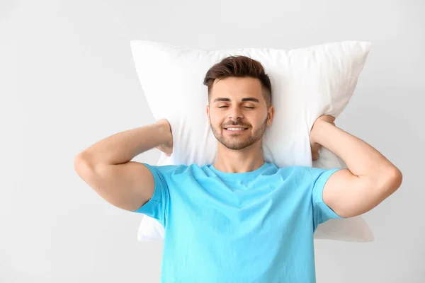 Handsome man with pillow against white background — Stock Photo, Image