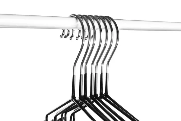Rack with clothes hangers on white background, closeup — Stock Photo, Image