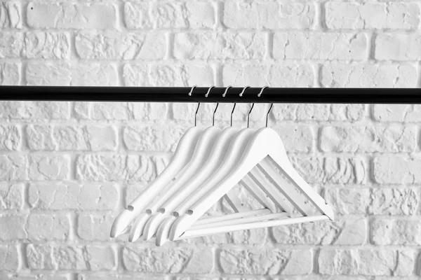 Rack with clothes hangers on white background — Stock Photo, Image