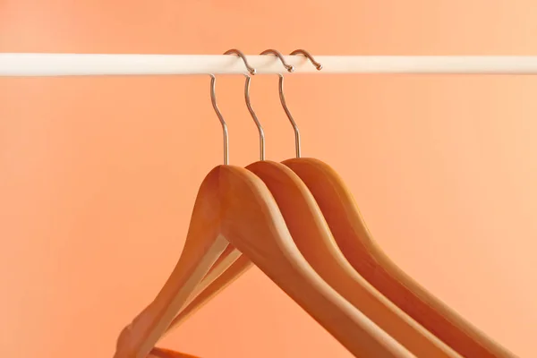 Rack met kleding hangers op kleur achtergrond — Stockfoto