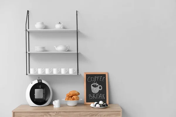 Modern coffee machine and croissants on kitchen table — Stock Photo, Image