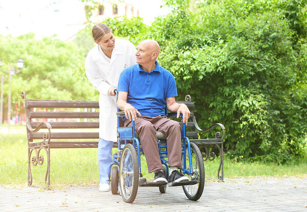 Elderly man with caregiver in park