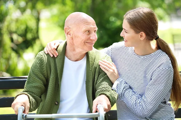 Elderly man with his daughter in park — Stock Photo, Image