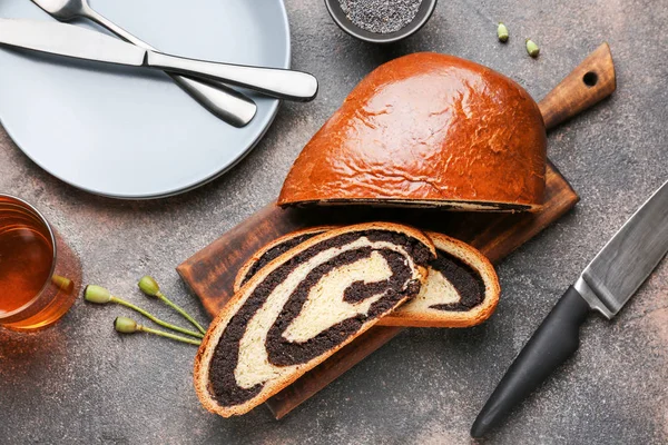 Tasty cut poppy bun on grey table — Stock Photo, Image