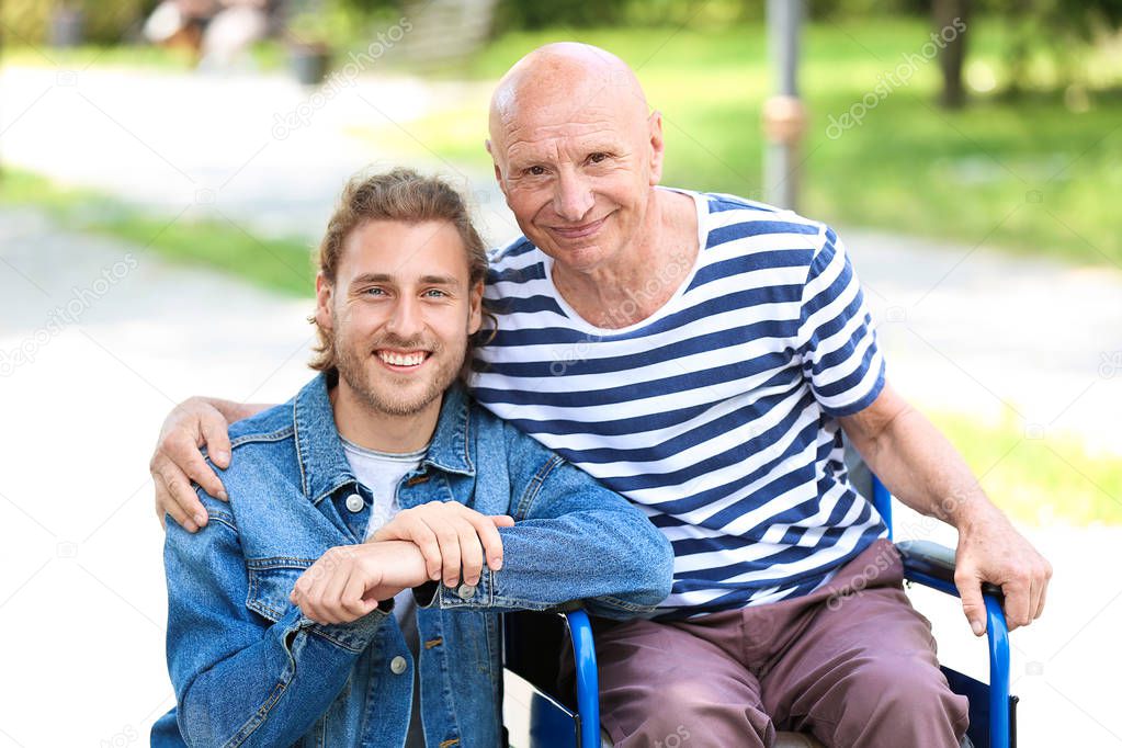 Elderly man with his son in park