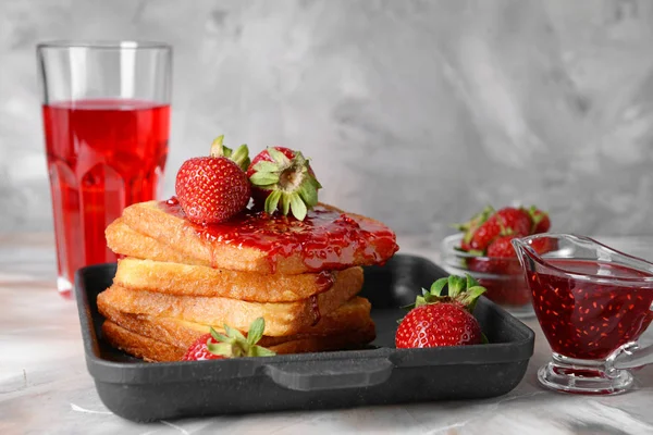 Frying pan with tasty French toasts and strawberry on grey table — Stock Photo, Image