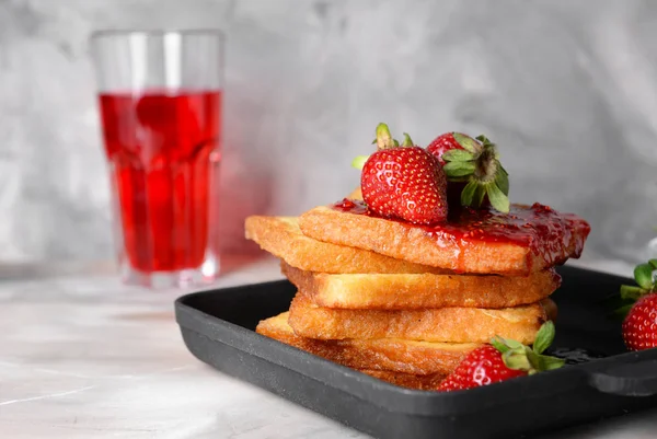 Frying pan with tasty French toasts and strawberry on grey table — Stock Photo, Image