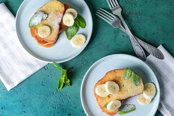 Desky s chutnými francouzskými toasty a banánem na pozadí barev — Stock fotografie