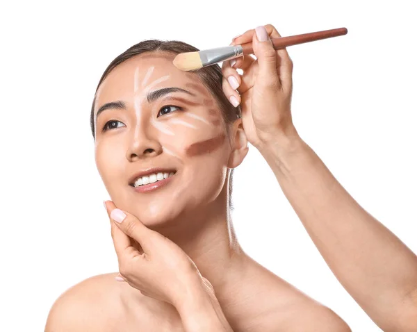 Maquillaje artista trabajando con modelo sobre fondo blanco — Foto de Stock