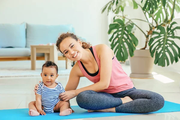 African-American mother training with cute little baby at home — Stock Photo, Image