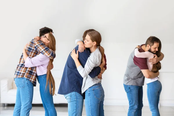 Hugging young people at group therapy session — Stock Photo, Image