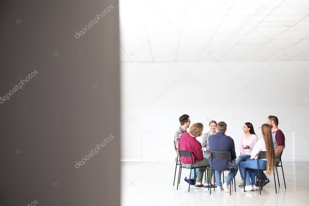 Young people with psychologist at group therapy session