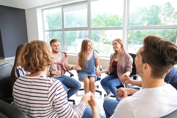 Ungdomar som håller händer tillsammans vid gruppterapi session — Stockfoto