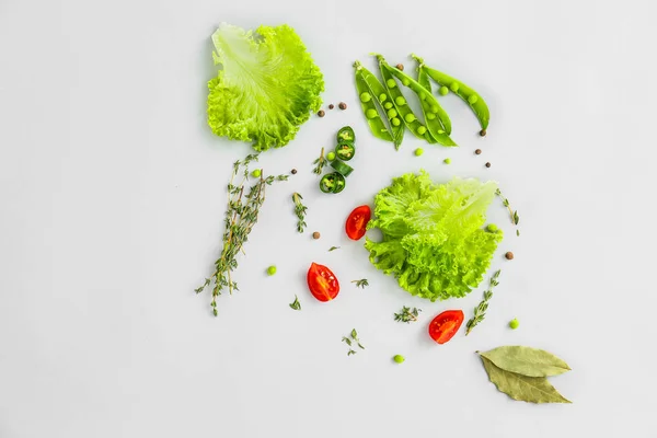 Fresh herbs with vegetables and spices on grey background — Stock Photo, Image