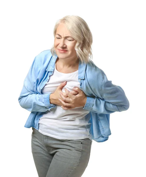 Mature woman suffering from heart attack on white background — Stock Photo, Image