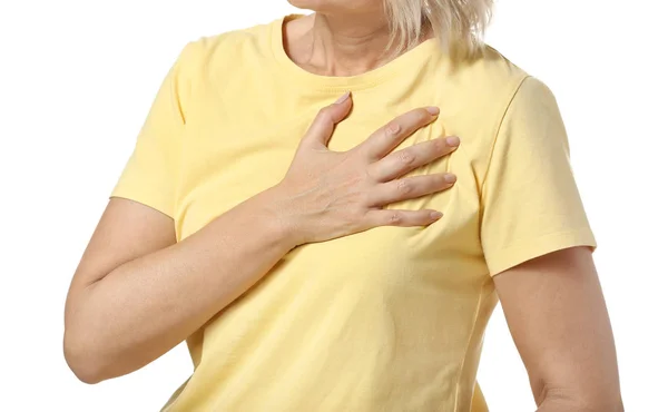 Mature woman suffering from heart attack on white background, closeup — Stock Photo, Image