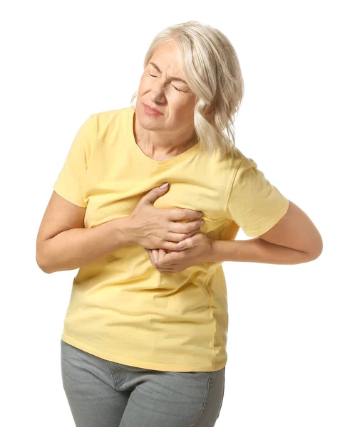 Mature woman suffering from heart attack on white background — Stock Photo, Image