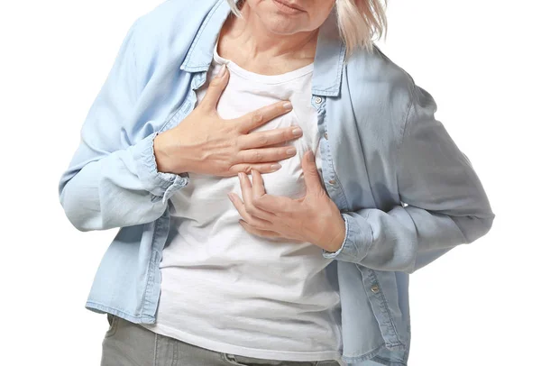 Mature woman suffering from heart attack on white background — Stock Photo, Image