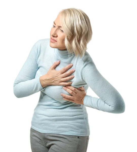 Mature woman suffering from heart attack on white background — Stock Photo, Image