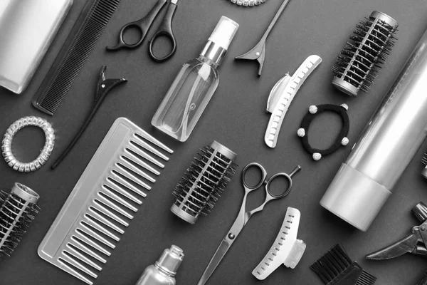 Set of hairdresser tools and accessories on dark background